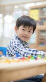 Smiling little boy playing with a toy train set in his school's classroom Fictional Character Created By Generative AI. 