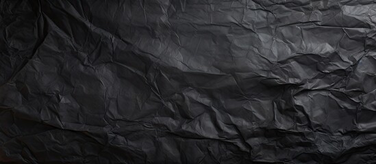 Poster - A grungy textured background with a copy space image featuring crumpled and creased black paper