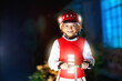 © famveldman - Safety on dark street. Kids reflective vest.
