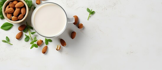 Aufkleber - Top view of a cup filled with almond milk surrounded by nuts and a potted plant placed on a white concrete background This non dairy and vegan composition creates a visually appealing copy space imag