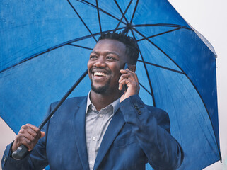 Canvas Print - Phone call, business and black man with umbrella, outdoor and communication with rain, smile and connection. Weather, African person and agent with cellphone, cover and network with app, city and wet