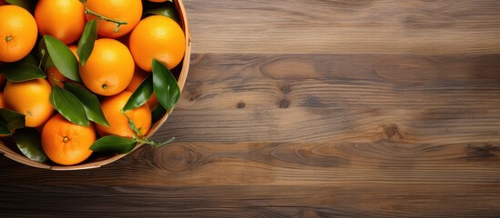 Canvas Print - The copy space image shows a top view of a basket filled with freshly picked oranges resting on a wooden table