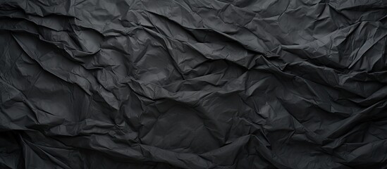 Poster - A grungy textured background with a copy space image featuring crumpled and creased black paper