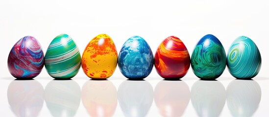 Fototapete - An image of painted Easter eggs on a white background allowing for additional text or design elements in the empty areas of the image