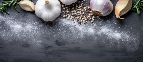 Aufkleber - Top view of garlic rosemary black pepper and salt on a grey concrete background creating a visually appealing copy space image