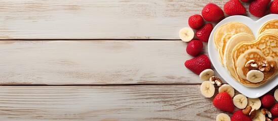 Sticker - Valentine s Day celebration with heart shaped pancakes dried banana and nuts on a light wooden background A delightful copy space image