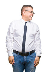 Wall Mural - Middle age bussines arab man wearing glasses over isolated background looking away to side with smile on face, natural expression. Laughing confident.