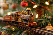 Toy train and railway under Christmas tree indoors. Celebration of Christmas and New Year.
