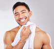 Man, portrait and towel in studio for skincare or hygiene, self care and daily morning grooming for wellness or dermatology. Person, isolated and white background with cosmetics and happiness.