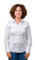 Wall Mural - Beautiful middle ager senior businees woman over isolated background Relaxed with serious expression on face. Simple and natural looking at the camera.