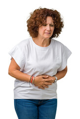 Canvas Print - Beautiful middle ager senior woman wearing white t-shirt over isolated background with hand on stomach because indigestion, painful illness feeling unwell. Ache concept.