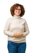 © Krakenimages.com - Beautiful middle ager senior woman wearing turtleneck sweater and glasses over isolated background Hands together and fingers crossed smiling relaxed and cheerful. Success and optimistic