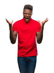 Wall Mural - Young african american man over isolated background celebrating mad and crazy for success with arms raised and closed eyes screaming excited. Winner concept