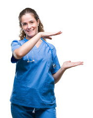 Poster - Young brunette doctor girl wearing nurse or surgeon uniform over isolated background gesturing with hands showing big and large size sign, measure symbol. Smiling looking at the camera