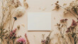 A photograph capturing the essence of simplicity and natural aesthetics with a blank white card mockup surrounded by artfully arranged dried flowers