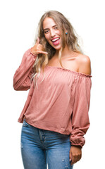 Wall Mural - Beautiful young blonde woman over isolated background smiling doing phone gesture with hand and fingers like talking on the telephone. Communicating concepts.