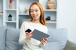 Happy Young Woman Using Tablet And Holding Credit Card On Couch, Online Shopping, Modern Lifestyle