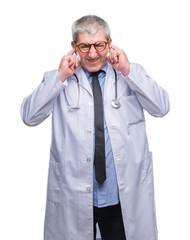 Sticker - Handsome senior doctor man over isolated background covering ears with fingers with annoyed expression for the noise of loud music. Deaf concept.