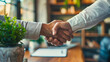Two people shaking hands in a business setting