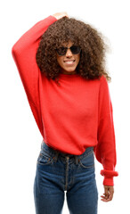 Poster - African american woman wearing sunglasses doubt expression, confuse and wonder concept, uncertain future