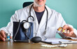Doctor prescribing medications on office table