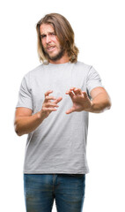 Sticker - Young handsome man with long hair over isolated background disgusted expression, displeased and fearful doing disgust face because aversion reaction. With hands raised. Annoying concept.