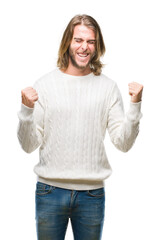 Sticker - Young handsome man with long hair wearing winter sweater over isolated background very happy and excited doing winner gesture with arms raised, smiling and screaming for success. Celebration concept.