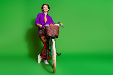 Poster - Photo of funny young woman wear purple shirt and brown bob haircut waiting with bicycle in summer isolated on green color background