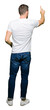 © Krakenimages.com - Handsome man wearing casual white t-shirt Posing backwards pointing behind with finger hand