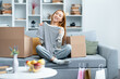 Happy Woman Unpacking Clothes In Living Room, New Home Unboxing, Comfortable Modern Interior, Relocation Concept