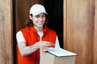 Friendly Delivery Man Handing Over Parcel In Casual Outfit, Smiling Young Male With White Cap And Red Vest Ensuring Speedy Service