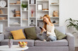 Young Woman Relaxing On Couch Using Smartphone In Modern Living Room, Cozy Home, Casual Style