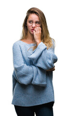 Sticker - Young beautiful blonde woman wearing sweater and glasses over isolated background looking stressed and nervous with hands on mouth biting nails. Anxiety problem.