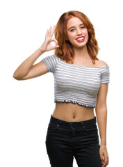 Wall Mural - Young beautiful woman over isolated background smiling positive doing ok sign with hand and fingers. Successful expression.