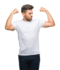 Sticker - Young handsome man over isolated background showing arms muscles smiling proud. Fitness concept.