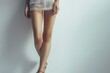 © Jorge Ferreiro - Young woman with beautiful long legs on white background