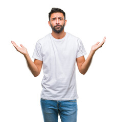 Wall Mural - Adult hispanic man over isolated background clueless and confused expression with arms and hands raised. Doubt concept.