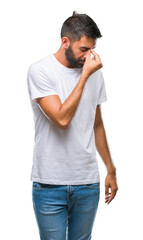 Wall Mural - Adult hispanic man over isolated background tired rubbing nose and eyes feeling fatigue and headache. Stress and frustration concept.