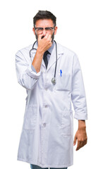 Sticker - Adult hispanic doctor man over isolated background smelling something stinky and disgusting, intolerable smell, holding breath with fingers on nose. Bad smells concept.