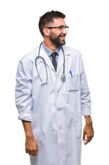 Wall Mural - Adult hispanic doctor man over isolated background looking away to side with smile on face, natural expression. Laughing confident.