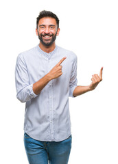 Wall Mural - Adult hispanic man over isolated background smiling and looking at the camera pointing with two hands and fingers to the side.
