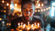 Man blowing out birthday candles on a cake making a heartfelt wish