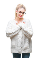 Sticker - Young beautiful blonde woman wearing glasses over isolated background smiling with hands on chest with closed eyes and grateful gesture on face. Health concept.