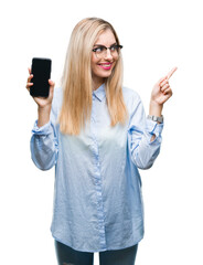 Sticker - Young beautiful blonde business woman showing screen of smartphone over isolated background very happy pointing with hand and finger to the side