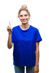 Sticker - Young beautiful blonde and blue eyes woman wearing blue t-shirt over isolated background showing and pointing up with finger number one while smiling confident and happy.