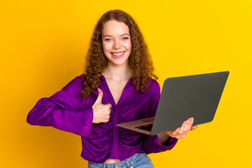 Sticker - Photo portrait of lovely young lady hold netbook thumb up dressed stylish violet garment isolated on yellow color background