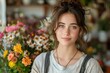 Young woman with a gentle smile surrounded by vibrant flowers in a cozy florist shop, exuding natural beauty and entrepreneurial spirit