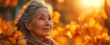 Mature woman smiling contently surrounded by golden autumn foliage