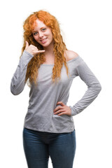 Canvas Print - Young redhead woman smiling doing phone gesture with hand and fingers like talking on the telephone. Communicating concepts.