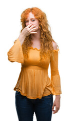 Wall Mural - Young redhead woman smelling something stinky and disgusting, intolerable smell, holding breath with fingers on nose. Bad smells concept.